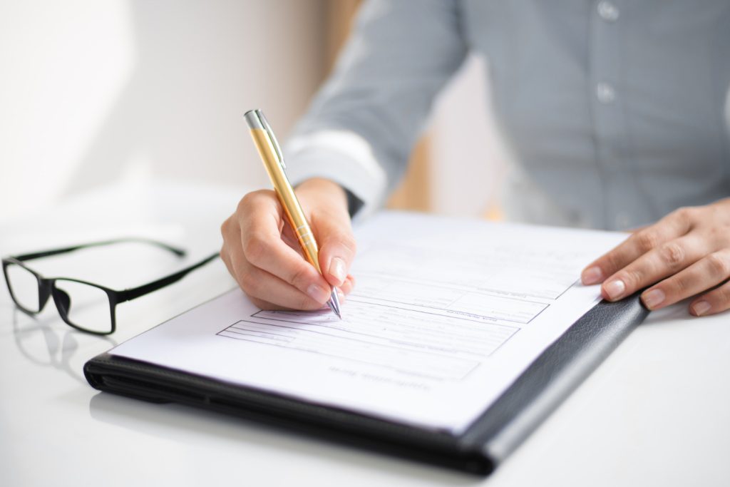 Closeup of business woman taking notes on a document